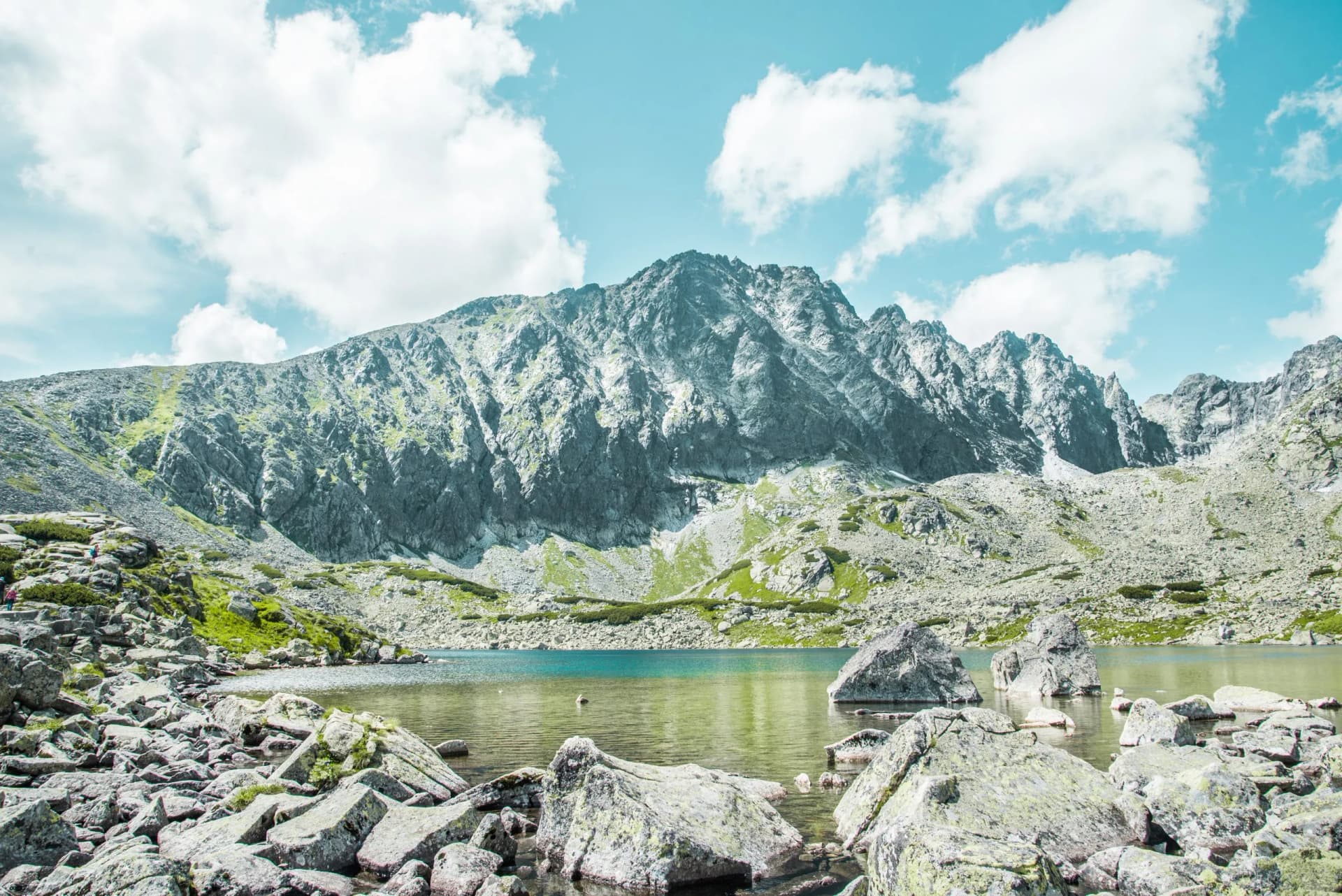 National Park High Tatras, Slovakia, Europe. Hiking path to mountain lake Batizovske pleso and Sliezsky dom (Selesian house). Summer scenery with blue sky, shining sun and protected Tatra flowers.