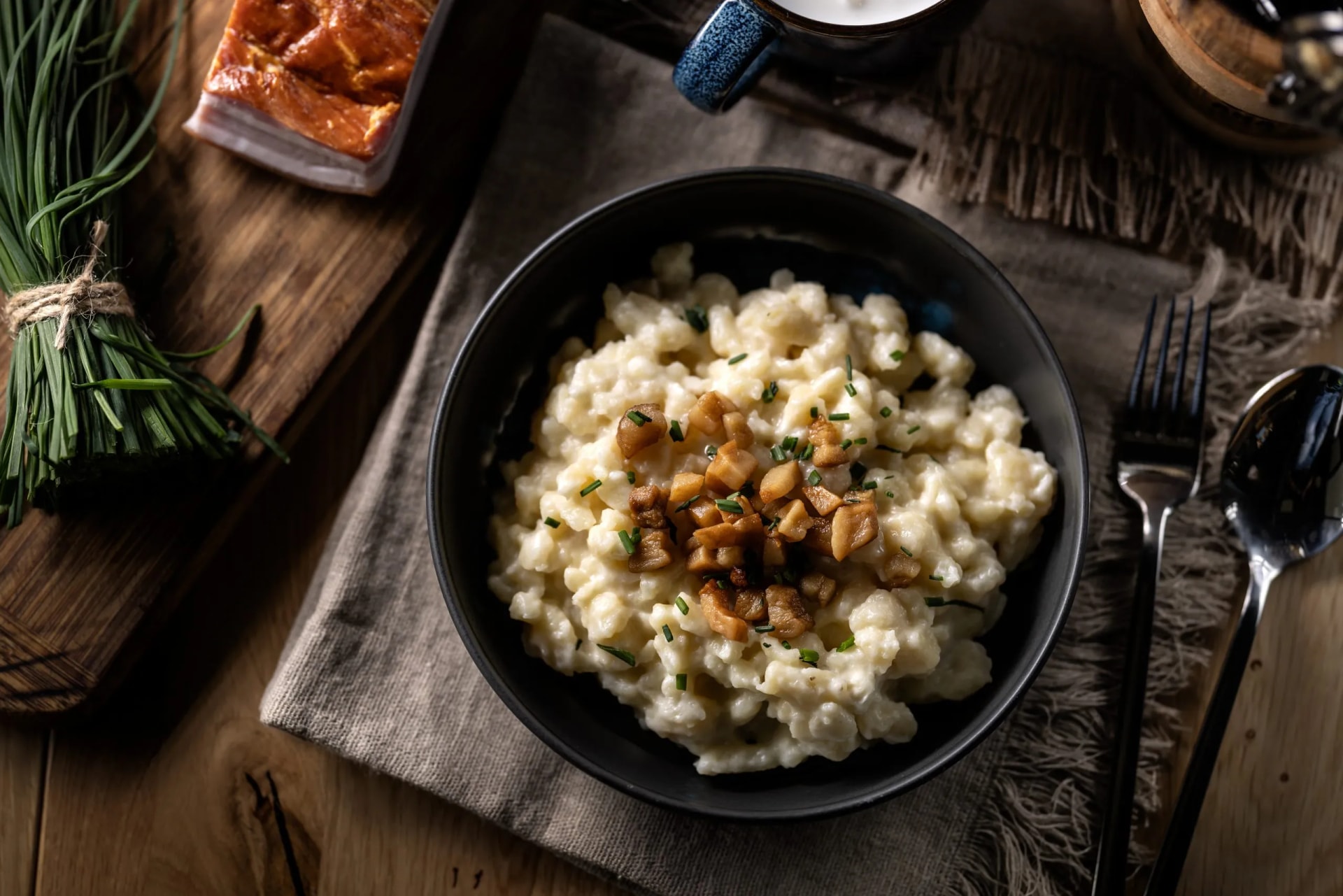 Halusky as traditional Slovak potato gnocchi with sheep cheese bryndza, fried bacon and chives