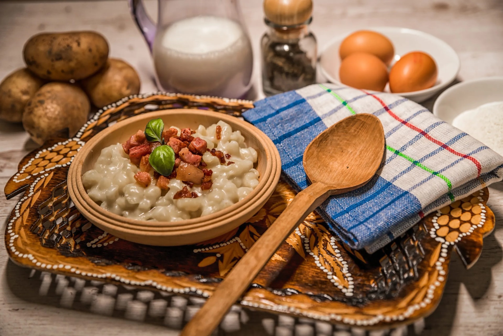 Slovak traditional dishes, potato gnocchi, bryndza, on wooden pancakes, potatoes, eggs. milk, sheep's cheese